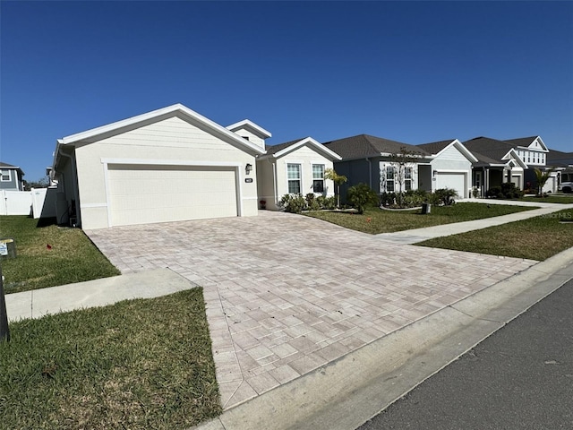 ranch-style house featuring a front yard and a garage