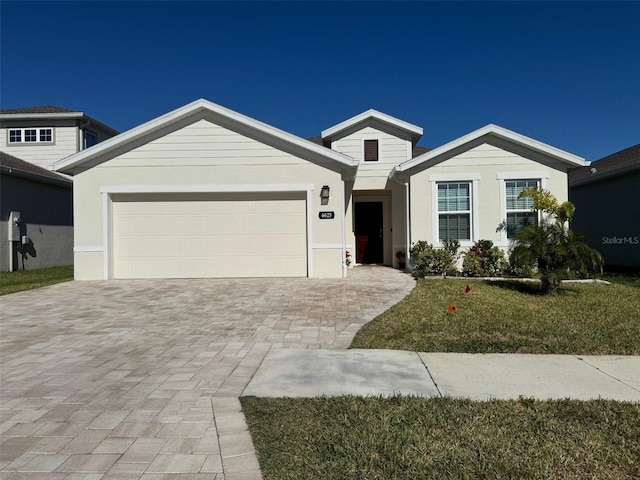 view of front of property with a garage and a front yard