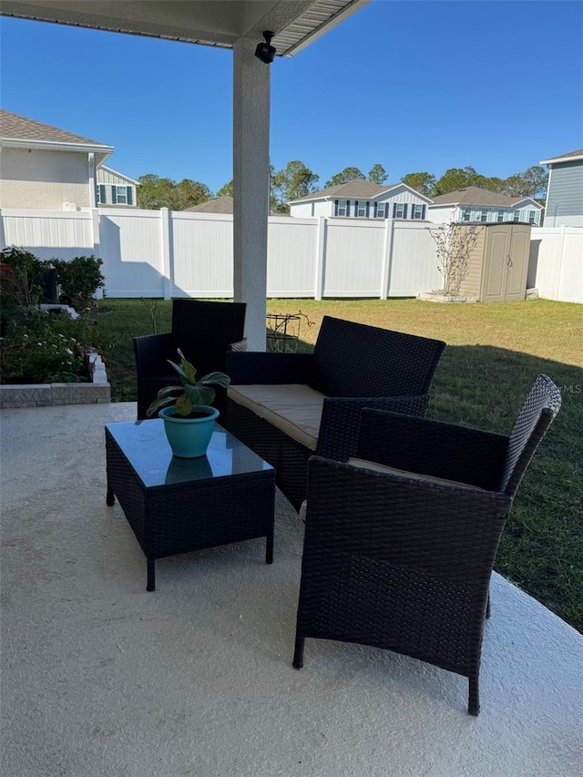 view of patio featuring an outdoor hangout area and a storage shed