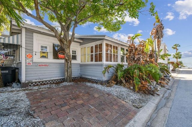 view of side of property with a sunroom