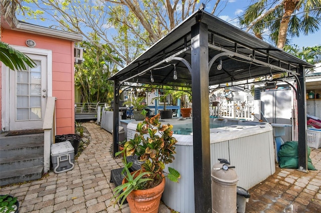 view of patio featuring a gazebo and a hot tub