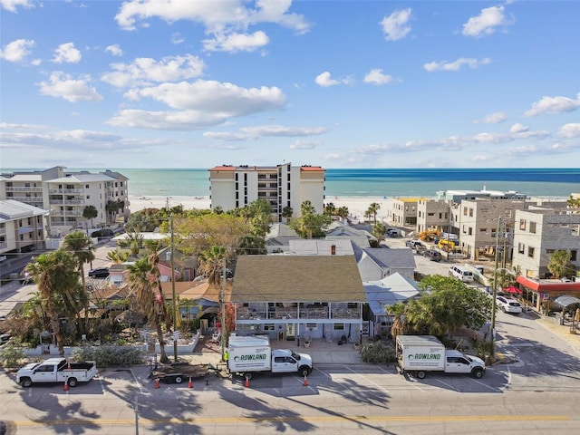 drone / aerial view featuring a beach view and a water view