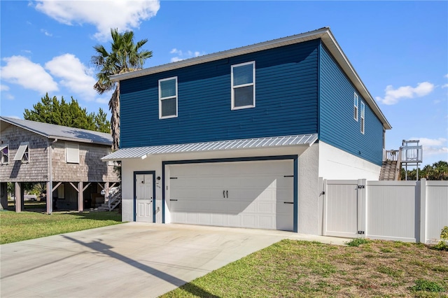 view of front of house with a garage and a front lawn