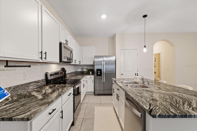 kitchen with white cabinetry, sink, pendant lighting, a center island with sink, and appliances with stainless steel finishes