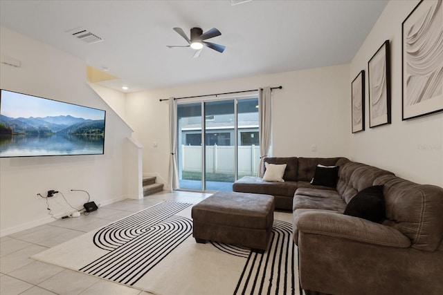 living room featuring light tile patterned floors and ceiling fan