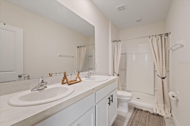 bathroom with tile patterned floors, vanity, walk in shower, and toilet