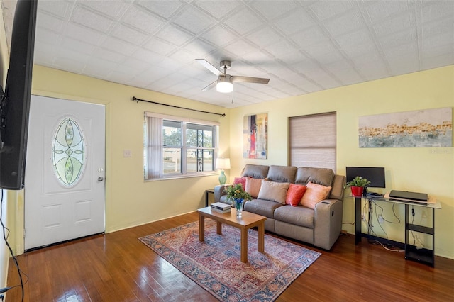 living room featuring ceiling fan and dark wood-type flooring