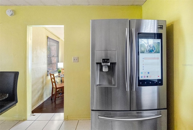 kitchen with stainless steel fridge with ice dispenser and light tile patterned floors