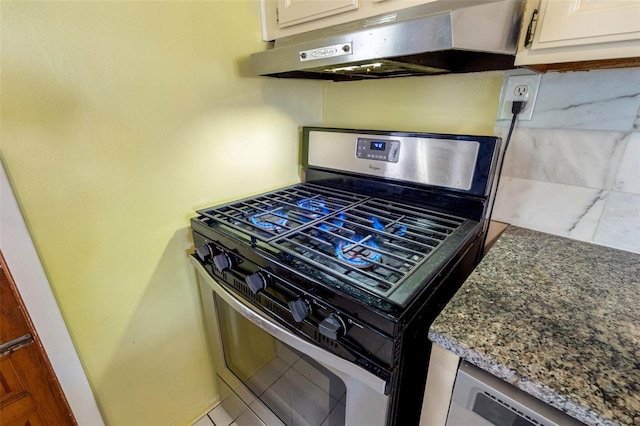 kitchen with stone countertops, white cabinetry, and stainless steel range with gas cooktop