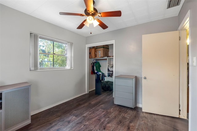 bedroom featuring dark wood-type flooring, ceiling fan, and a closet