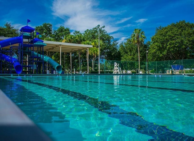 view of pool featuring a playground