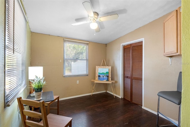 living area with ceiling fan and dark wood-type flooring