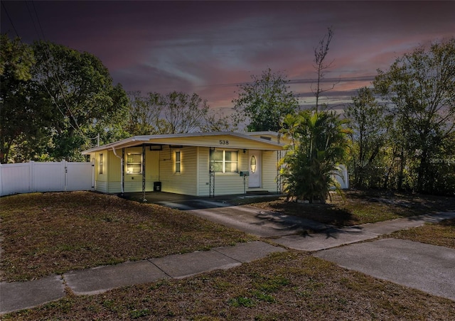 view of front of property featuring a carport