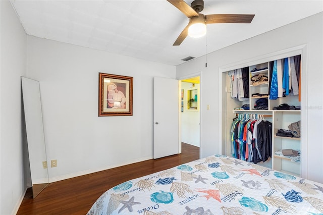 bedroom with ceiling fan, dark hardwood / wood-style flooring, and a closet