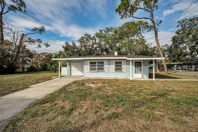 ranch-style house featuring a front yard and a carport