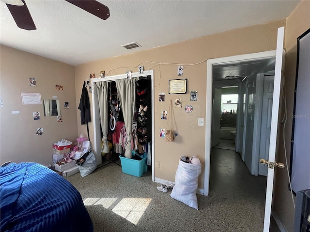 bedroom featuring ceiling fan and a closet