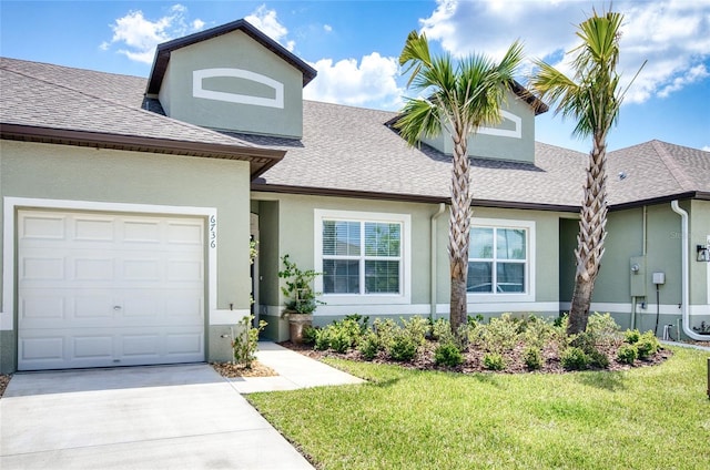 view of front of property featuring a garage and a front lawn