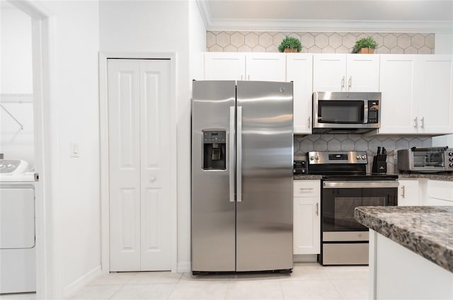 kitchen with light tile patterned floors, tasteful backsplash, appliances with stainless steel finishes, ornamental molding, and white cabinetry