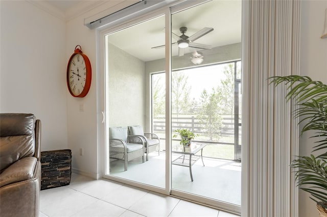 doorway with ornamental molding, ceiling fan, and light tile patterned floors