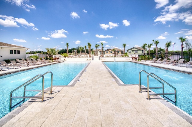 pool with fence and a patio