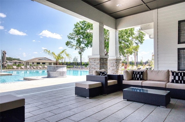 view of patio / terrace featuring outdoor lounge area and a community pool