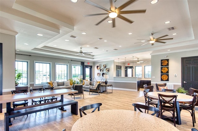 dining area with visible vents, a tray ceiling, and a wealth of natural light