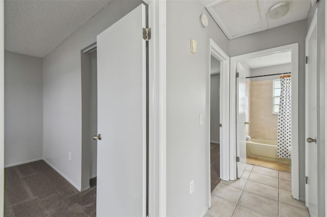 corridor with light tile patterned floors