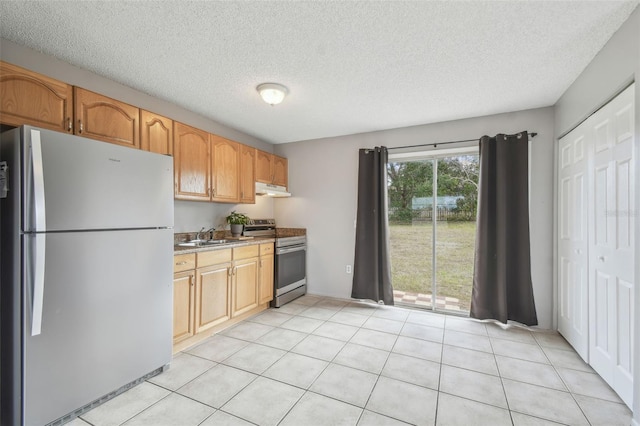 kitchen featuring electric stove, sink, light tile patterned flooring, and fridge