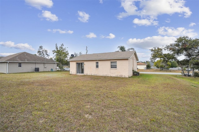 rear view of property with a yard