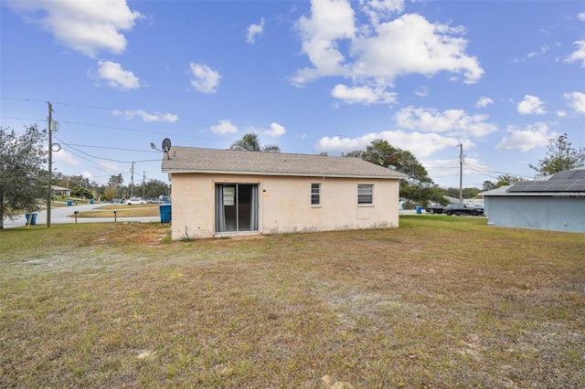 back of property featuring a yard