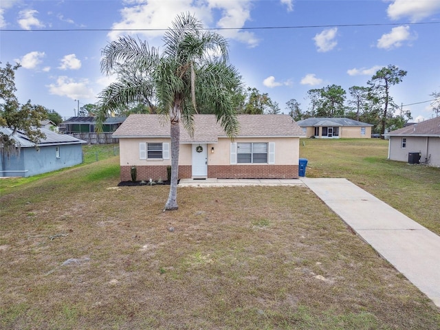 ranch-style house with cooling unit and a front yard