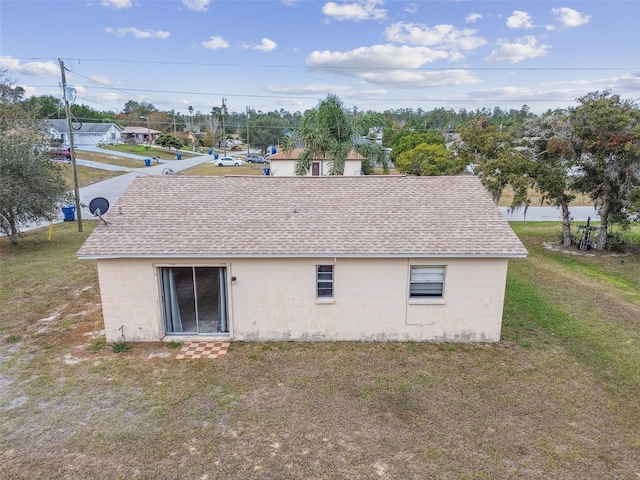 back of property featuring a lawn