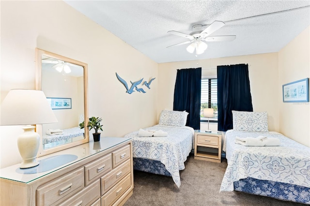 carpeted bedroom featuring ceiling fan and a textured ceiling