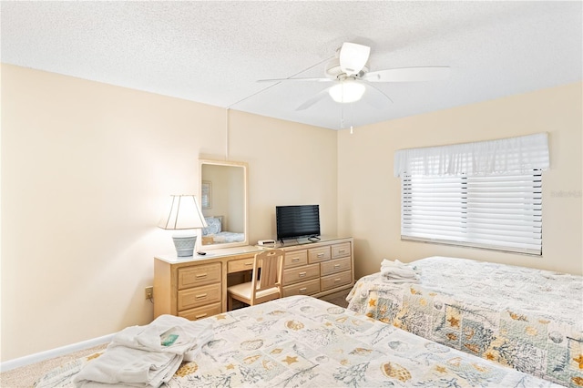 carpeted bedroom featuring a textured ceiling and ceiling fan