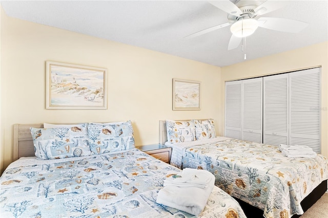 carpeted bedroom with ceiling fan and a closet