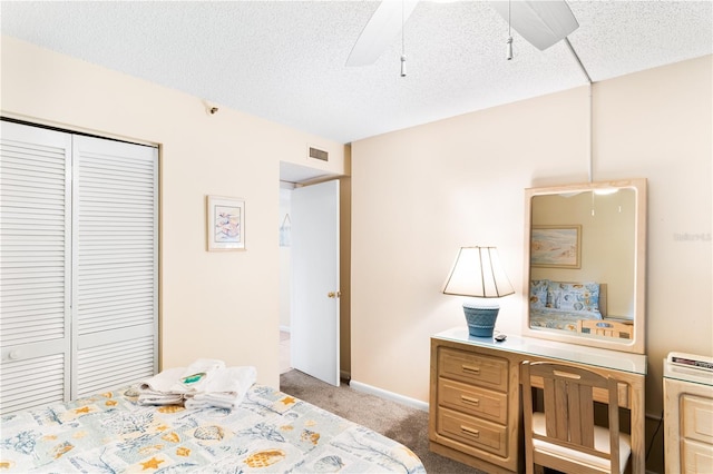 carpeted bedroom with ceiling fan and a closet