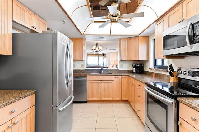 kitchen featuring sink, light brown cabinetry, light tile patterned flooring, ceiling fan with notable chandelier, and appliances with stainless steel finishes