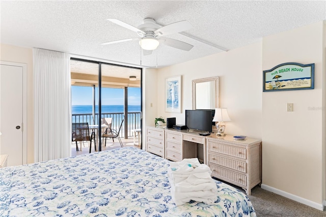 bedroom with access to exterior, ceiling fan, floor to ceiling windows, light colored carpet, and a textured ceiling