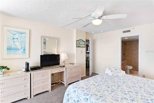 bedroom featuring ensuite bath, ceiling fan, light carpet, and a textured ceiling