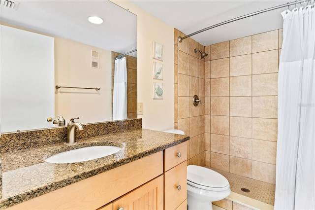 bathroom with vanity, toilet, and curtained shower