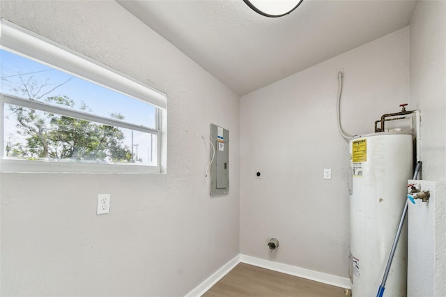 clothes washing area featuring electric dryer hookup, gas water heater, wood-type flooring, and electric panel