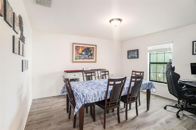 dining space featuring hardwood / wood-style floors