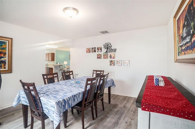 dining area with wood-type flooring