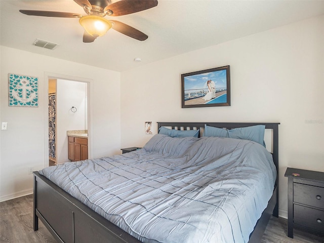 bedroom with ceiling fan, wood-type flooring, and connected bathroom