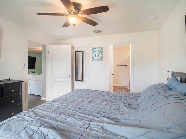 bedroom with ceiling fan and dark wood-type flooring