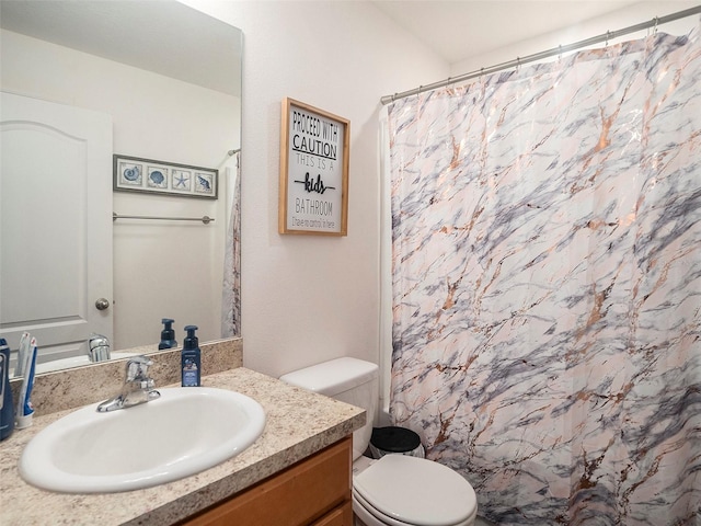 bathroom with curtained shower, vanity, and toilet