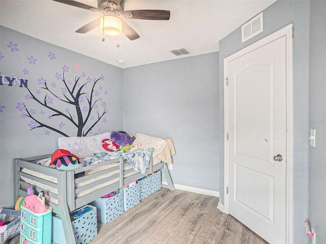 bedroom with light hardwood / wood-style floors and ceiling fan