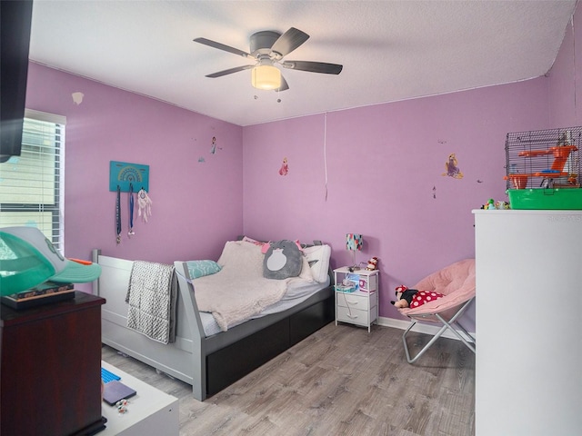 bedroom with ceiling fan and light hardwood / wood-style floors