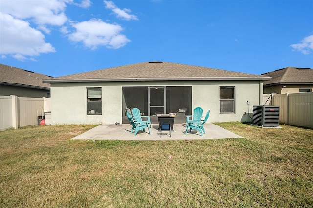 back of property with a yard, central AC, and a patio area