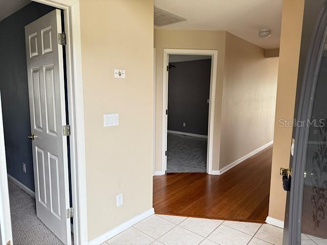 hallway with light tile patterned floors